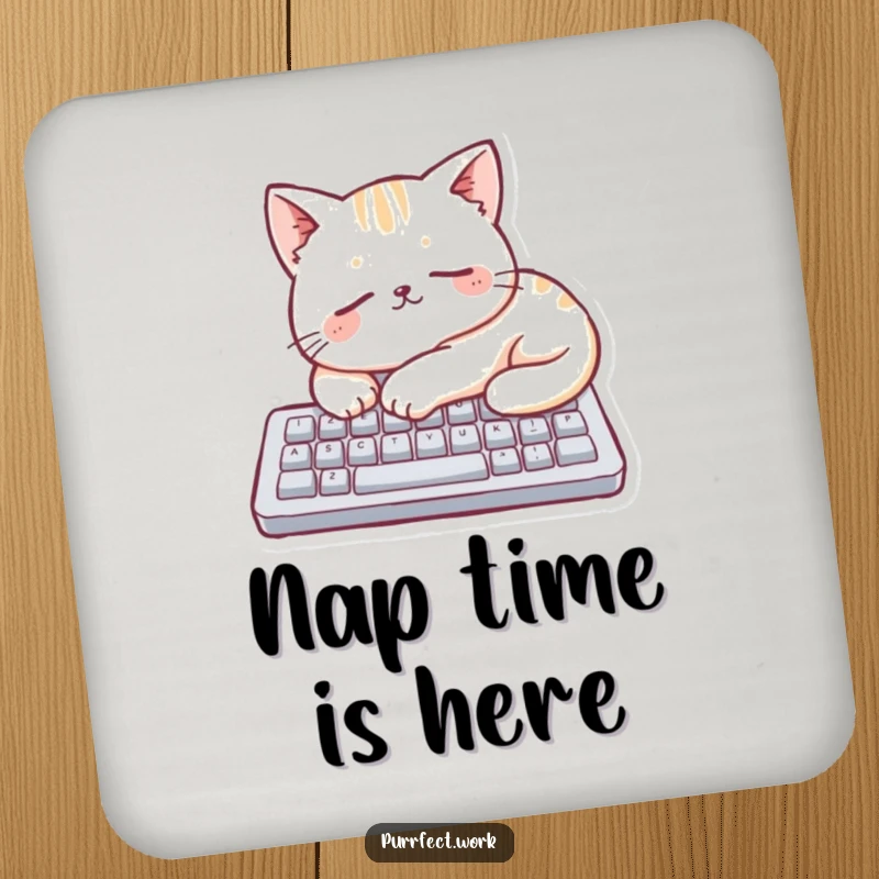 Funny cat character sleeping on a miniature keyboard on a protective drink coaster, adding a touch of humor.